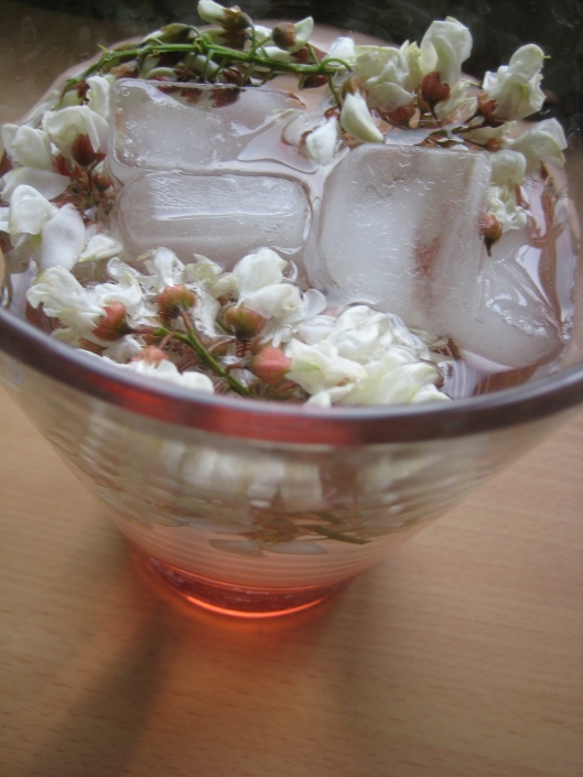 black locust flower infusion with ice and strawberry syrup